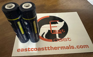 Two 18650 button top lithium batteries placed on a paper with 'East Coast Thermal & Night Vision' logo and website address.